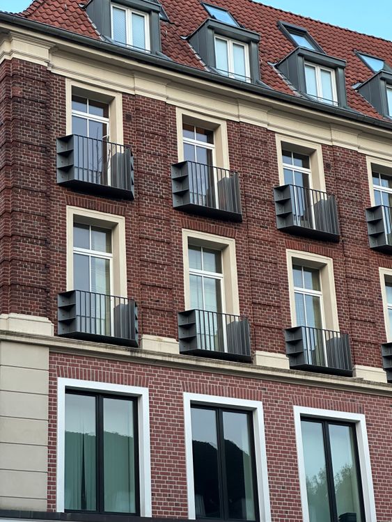 Elegant Brick Building Facade with Balconies · Free Stock Photo
