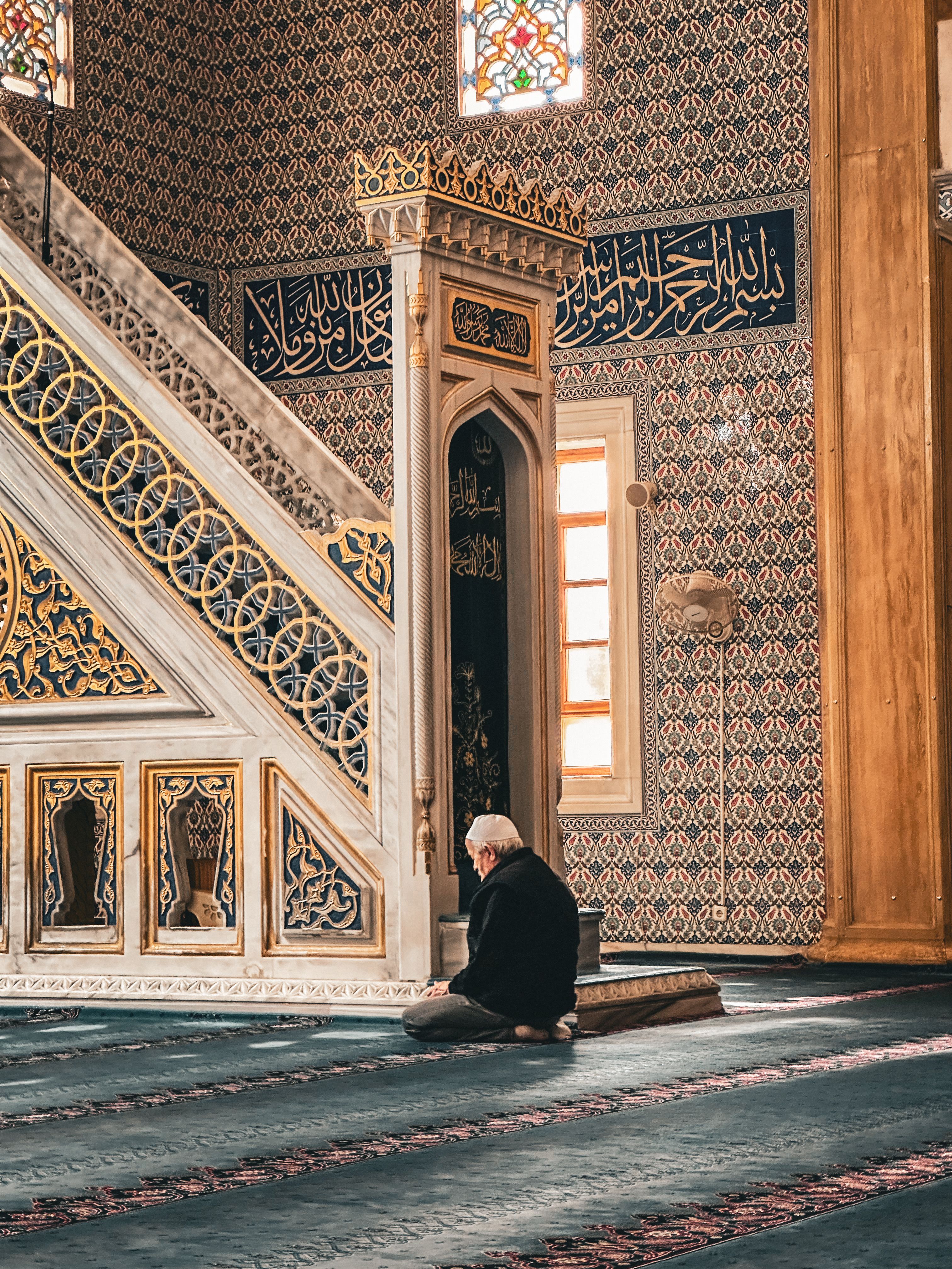 Man Praying in Historic Mosque Interior · Free Stock Photo