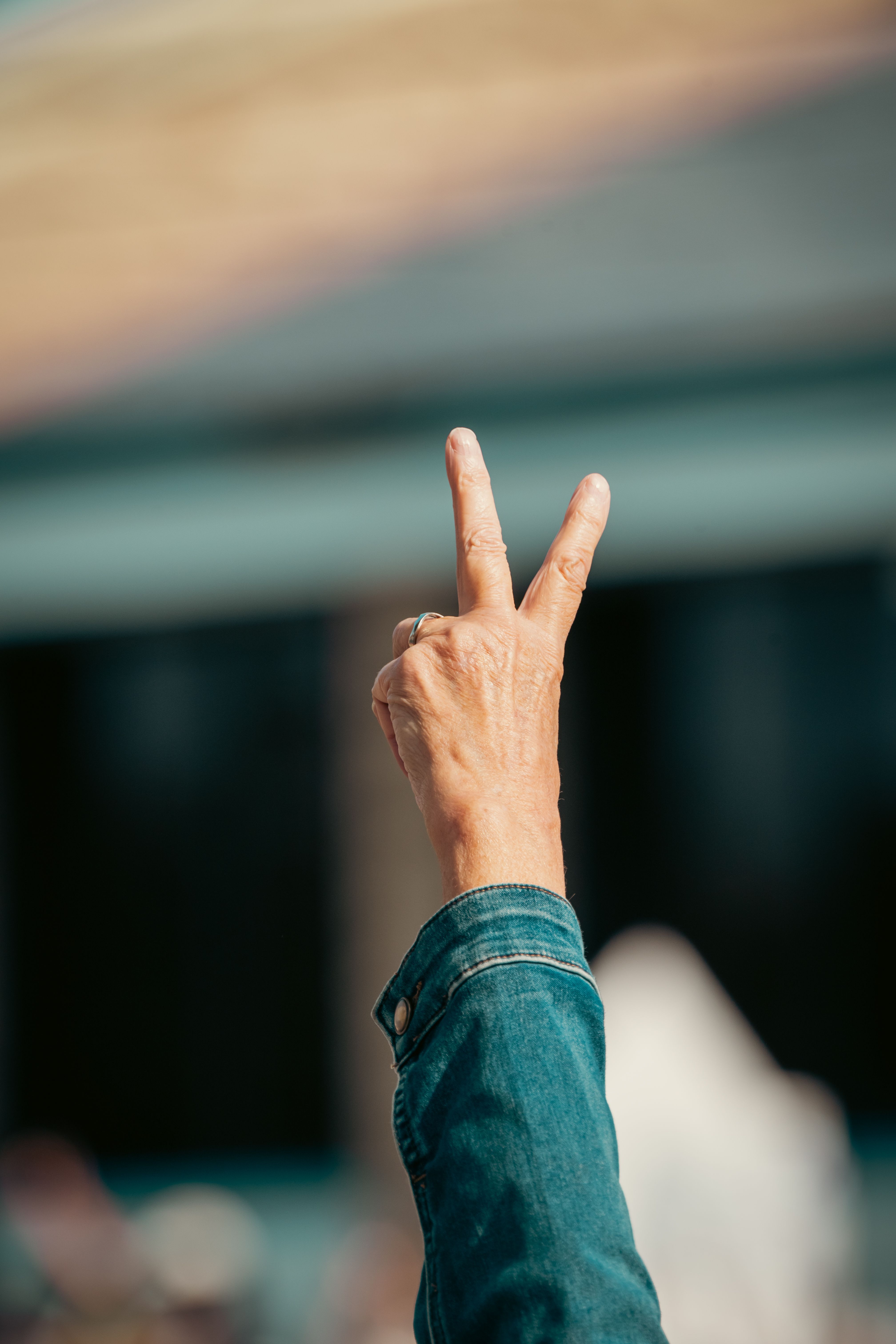 Peace Sign Hand Gesture Outdoors · Free Stock Photo