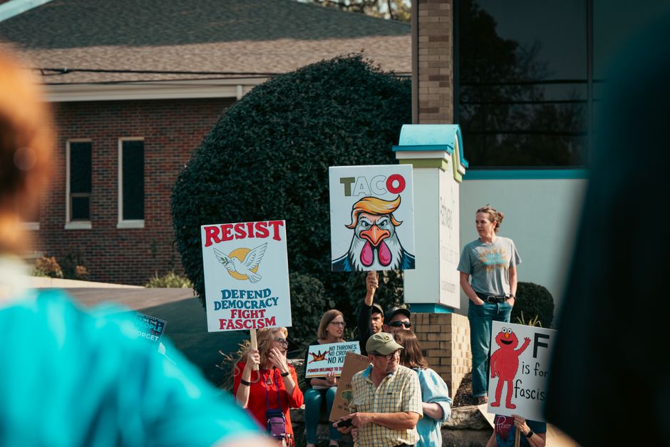 Community members holding signs at a protest for gambling reform