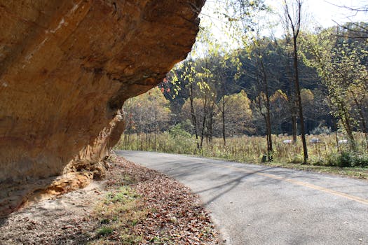 Enchanting road bend near natural rock formation in the Ohio countryside during fall.