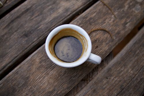 Free An empty espresso cup on a rustic wooden table, showcasing a finished drink. Stock Photo