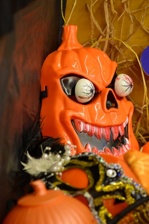 Free A creepy orange pumpkin mask with eerie eyes for Halloween decor. Stock Photo
