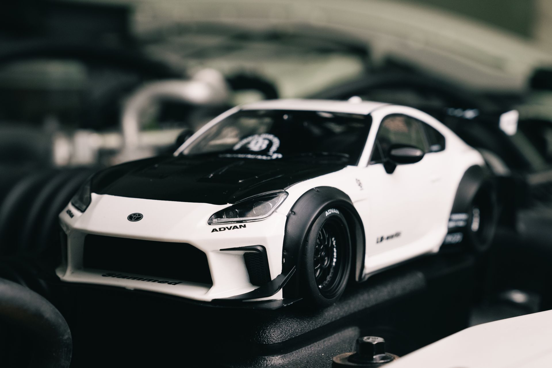High contrast image of a detailed black and white model sports car, showcasing automotive design.
