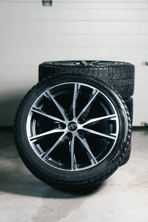 Stacked tyres and alloy wheels in a garage