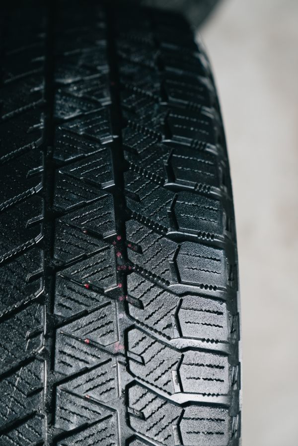 Close-up of a used tire's tread with plenty of depth left