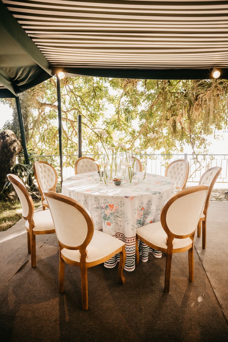 Elegant outdoor dining setup on a veranda with floral decor