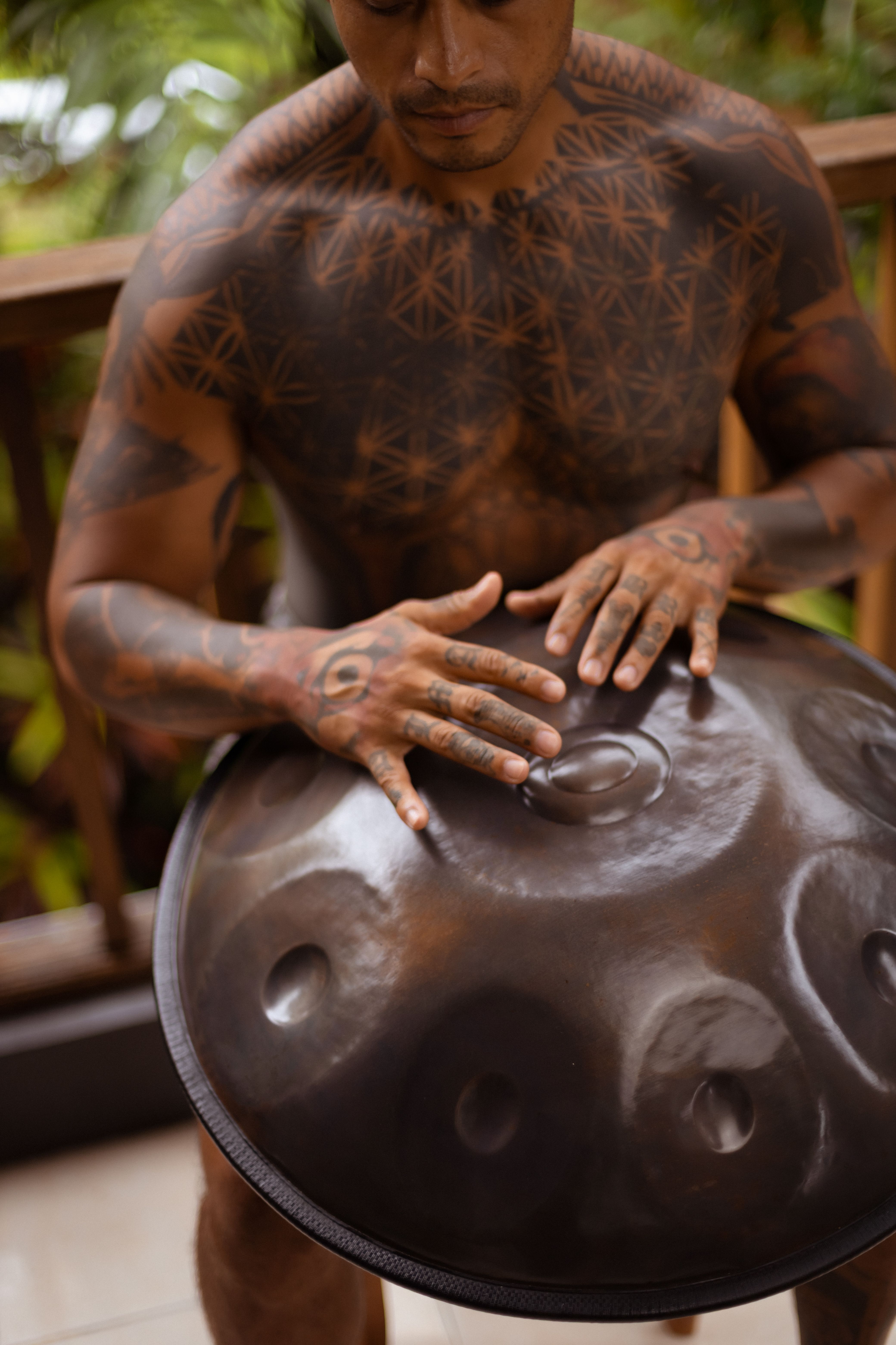 Man with Tattoos Playing a Handpan Outdoors · Free Stock Photo