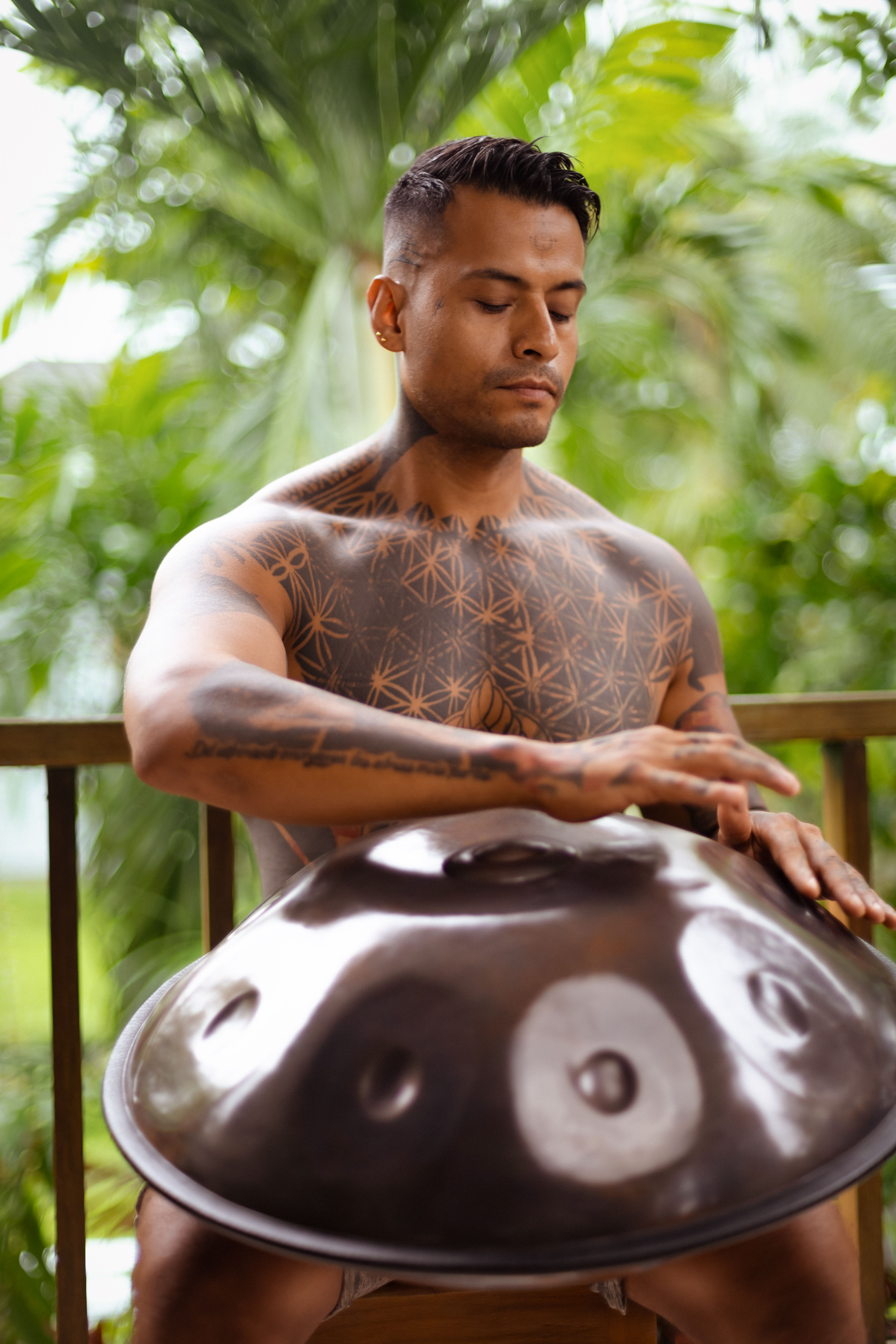 Man Playing Handpan in Tropical Setting · Free Stock Photo