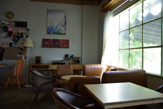 A cozy living room with vintage decor, ample natural light, and inviting seating arrangement. Perfect for relaxation.