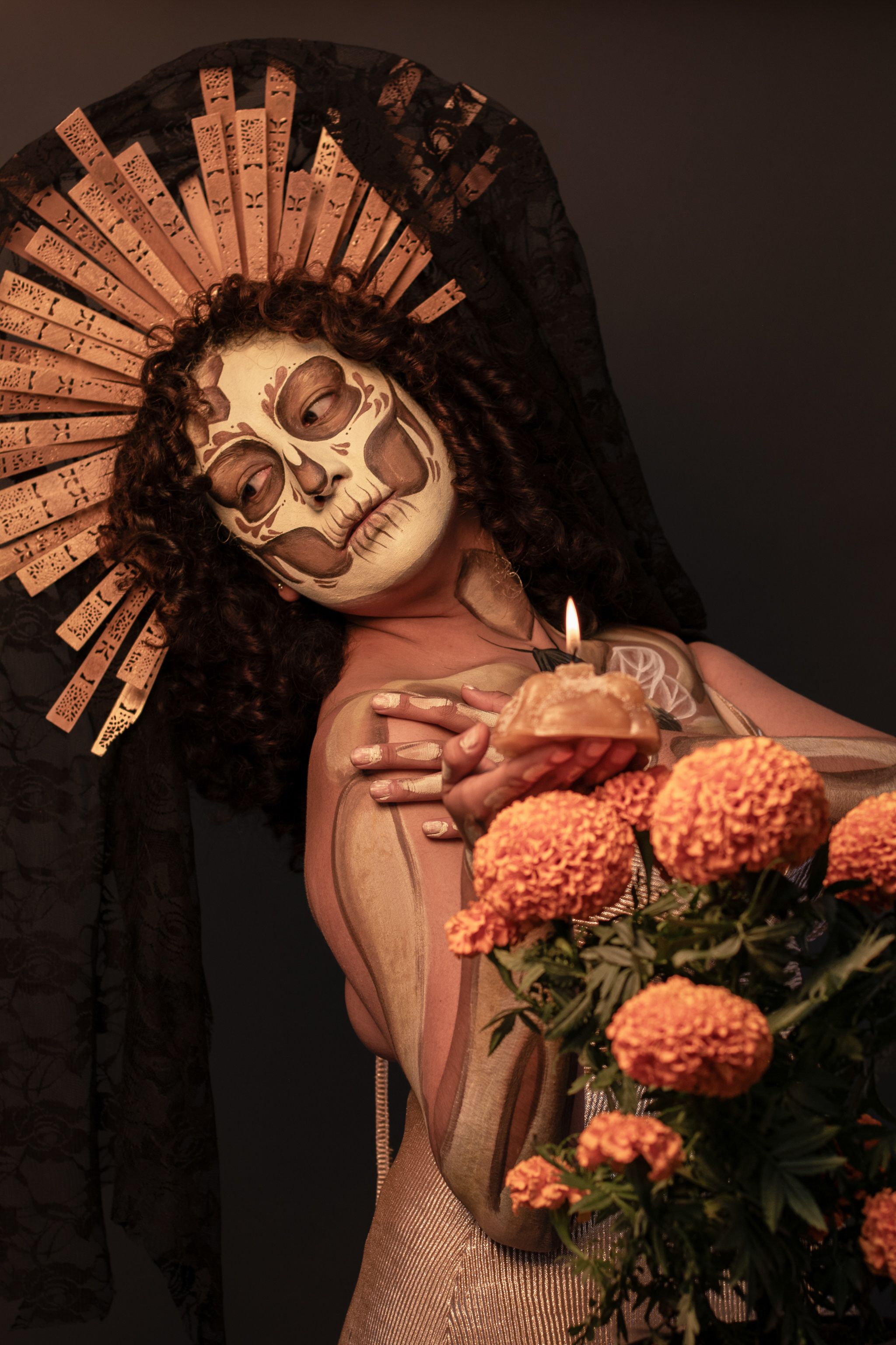 Creative depiction of Day of the Dead theme with face paint and marigold flowers.