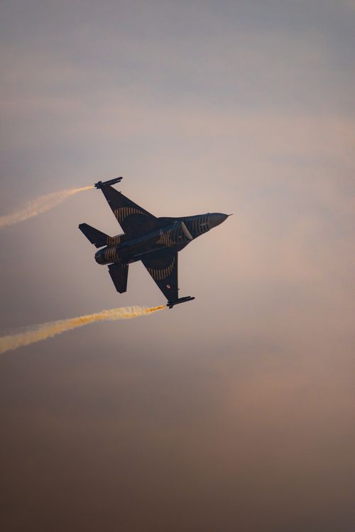 Free Military jet performing an aerial maneuver during twilight in the skies over Kayseri, Türkiye. Stock Photo