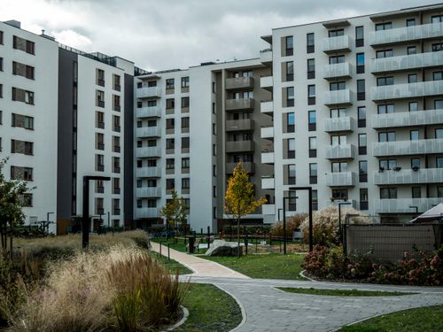 Free Contemporary apartment buildings with landscaped garden, showcasing urban residential architecture. Stock Photo