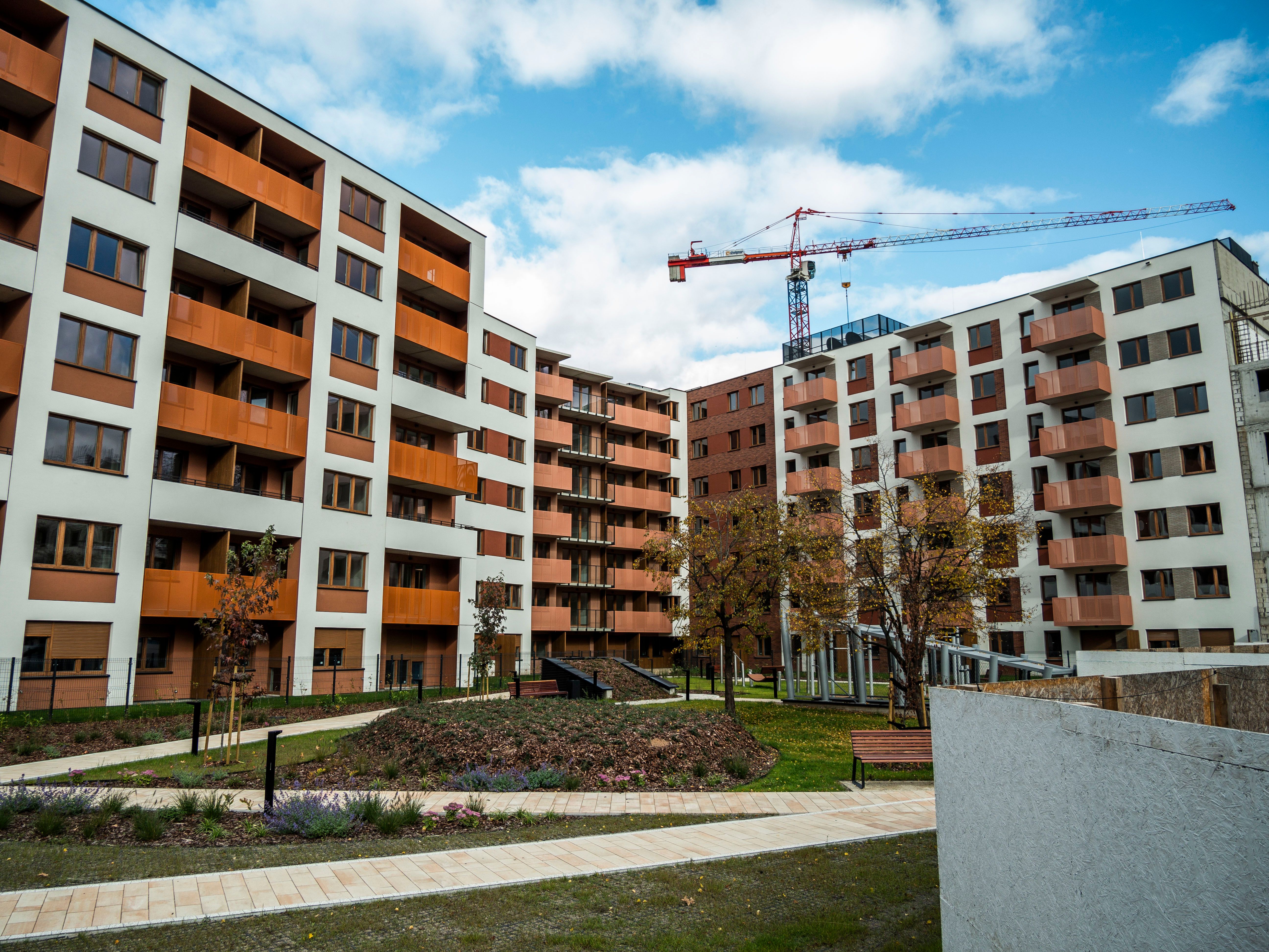 Modern apartment buildings with a construction crane above the multifamily development