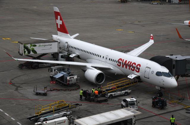 Swiss Airbus airplane being serviced on the tarmac of Geneva airport. — arriving in Geneva