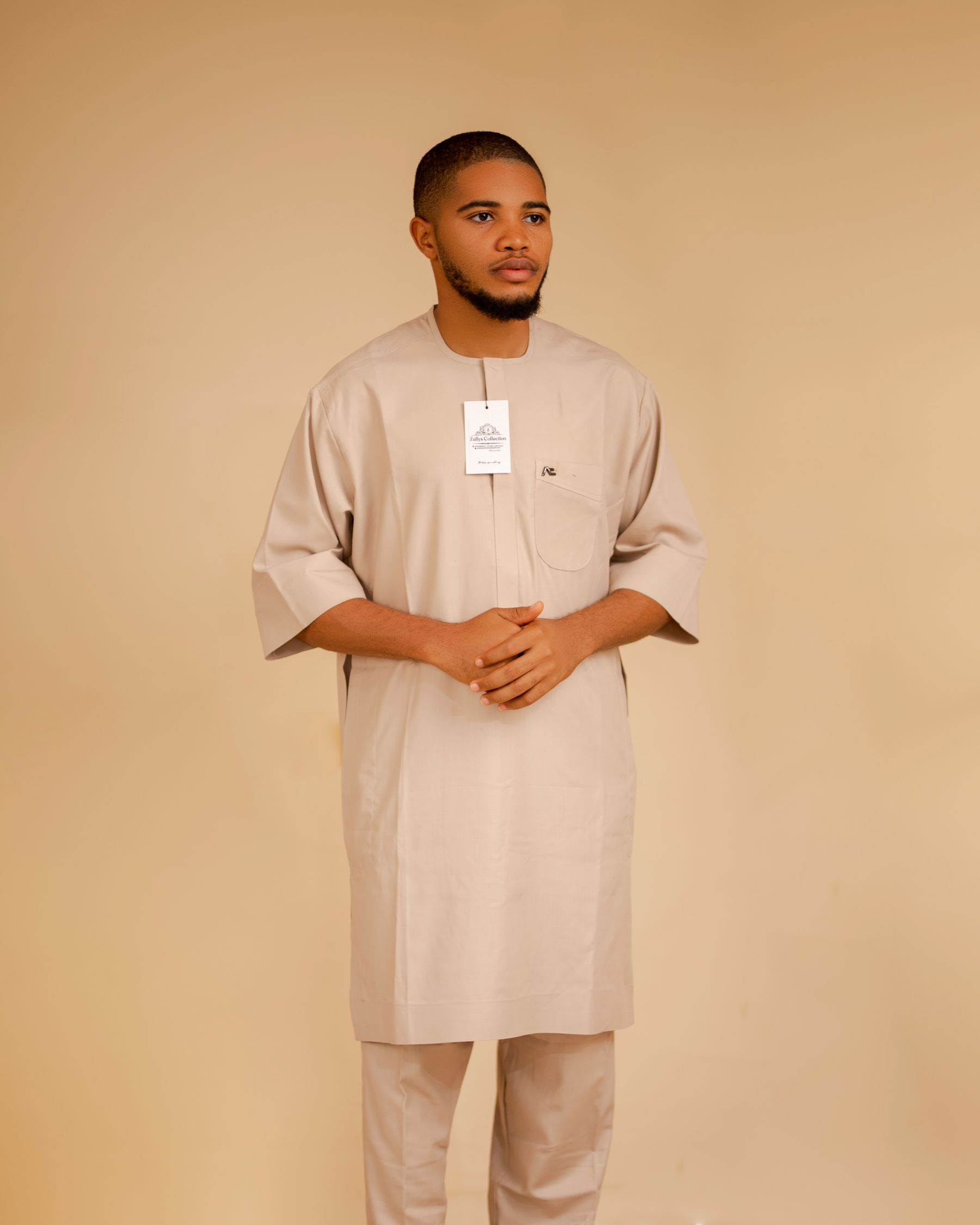 Executive wearing a precisely tailored neutral kaftan