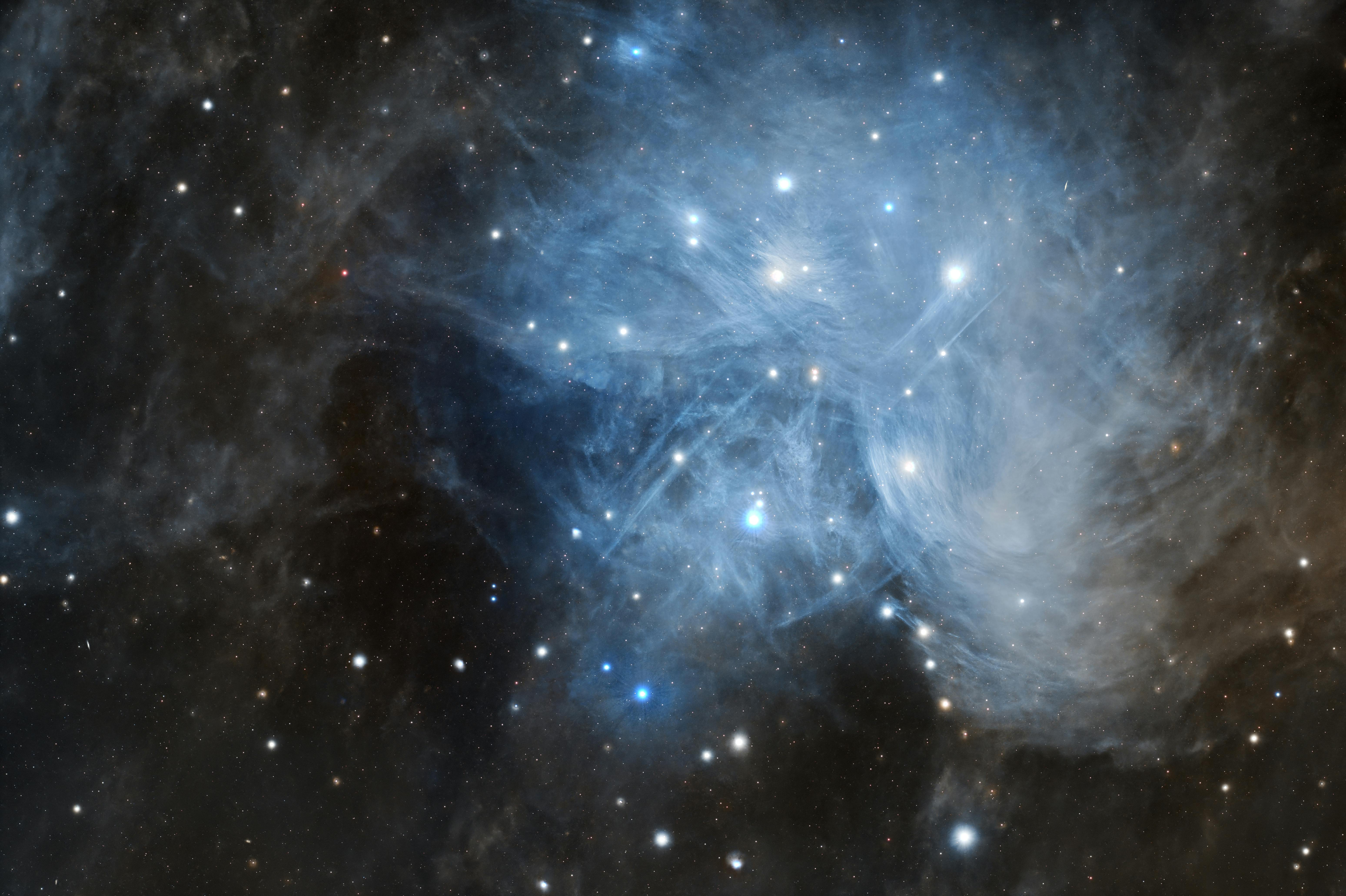 Captivating view of the Pleiades star cluster M45 with its glowing blue reflection nebula.
