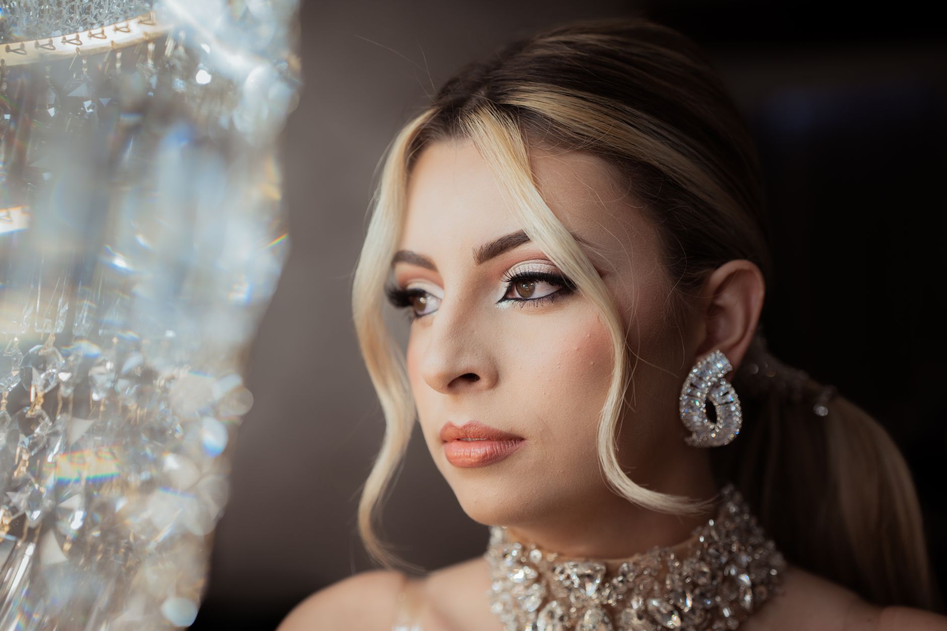 Close-up portrait of a glamorous woman wearing luxurious crystal jewelry, exuding elegance and sophistication.