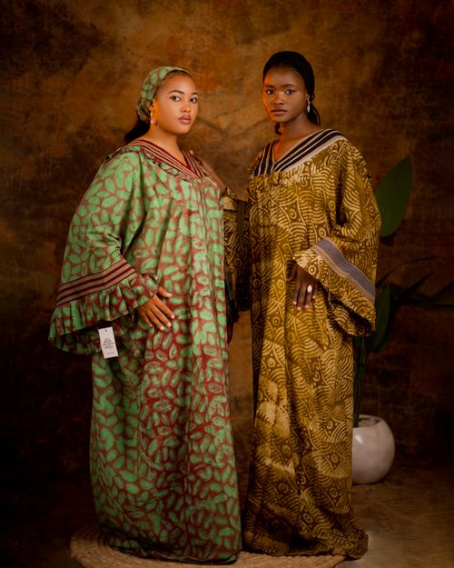 Free Two women in traditional African dresses pose elegantly in a studio setting. Stock Photo