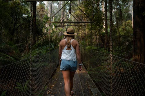 Photo Of Woman Walking On Bridge