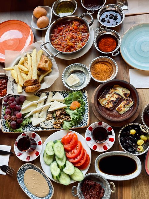 Free Delicious assortment of Turkish breakfast foods with fresh vegetables, cheeses, and condiments. Stock Photo