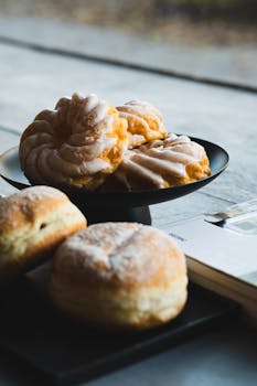 A selection of German donuts and pastries on a rustic table setting in soft daylight.