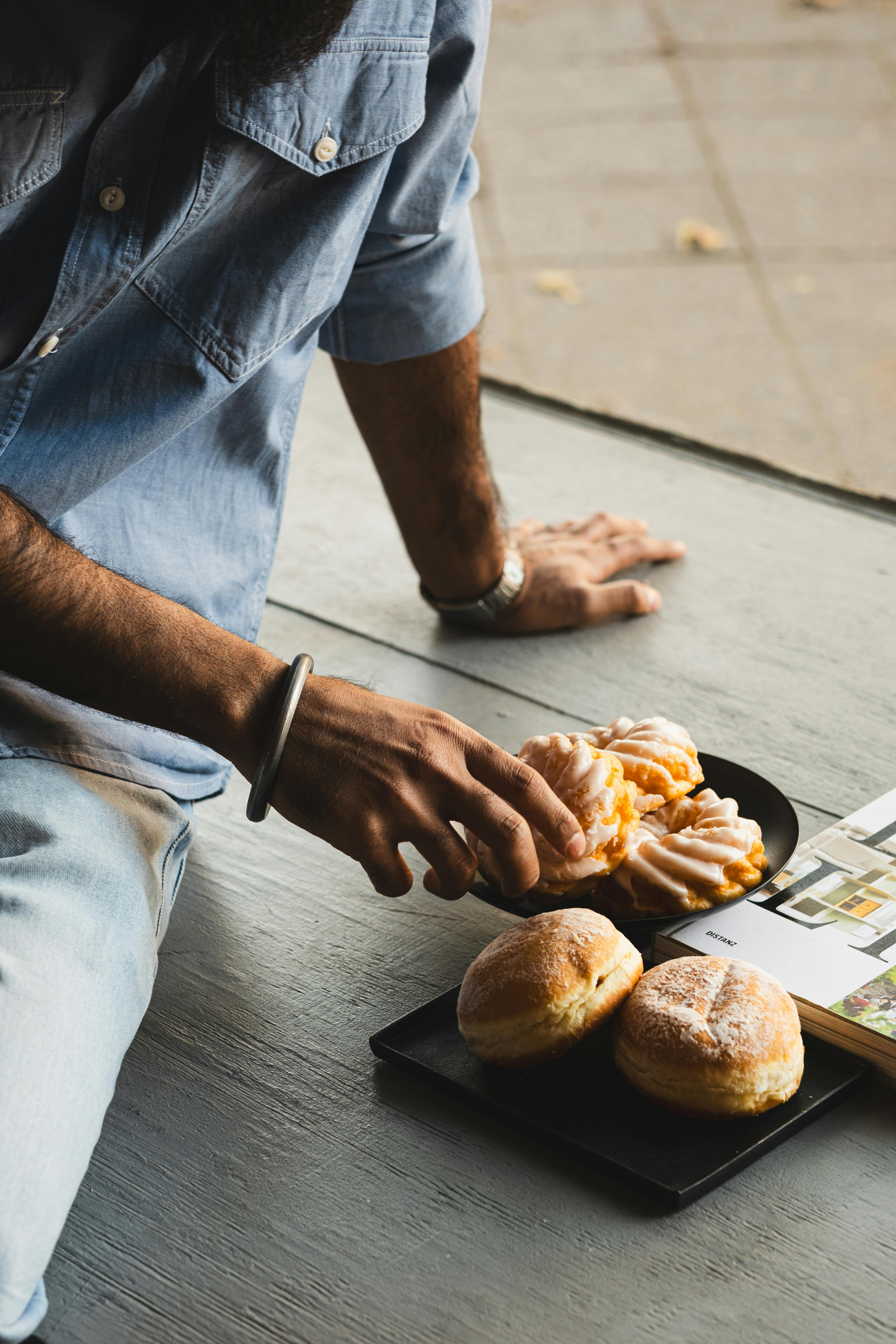 Man enjoying sweet pastries on a casual afternoon, showcasing German dessert culture.