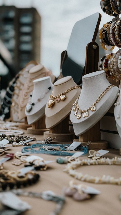 Free Chic display of necklaces and accessories at a street market. Urban shopping experience. Stock Photo