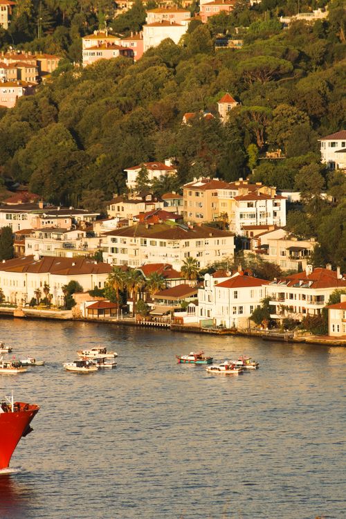 Free Charming sunset view of the Bosphorus with boats and hillside residences in Istanbul. Stock Photo