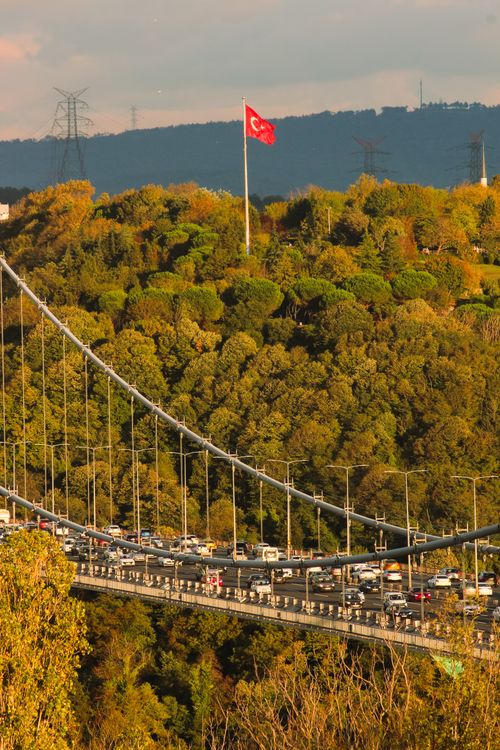 Free Suspension bridge over the Bosphorus with a Turkish flag in the background. Stock Photo