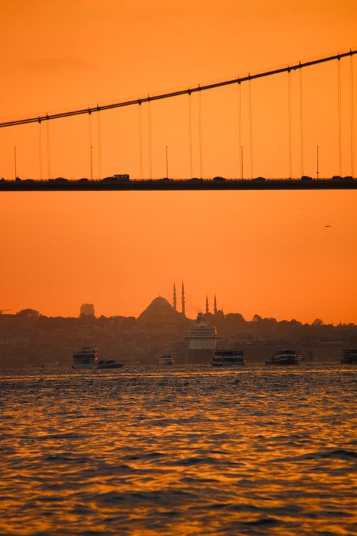 Free A breathtaking sunset over Istanbul with the Bosphorus Bridge silhouetted against the vibrant sky. Stock Photo