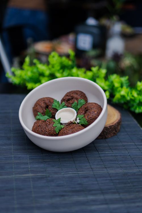 Free A bowl of falafel with fresh parsley and tahini sauce, perfect for Middle Eastern cuisine enthusiasts. Stock Photo