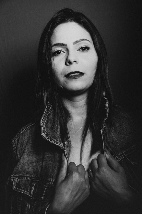 Free Elegant black and white portrait of a woman wearing a denim jacket, exuding confidence. Stock Photo