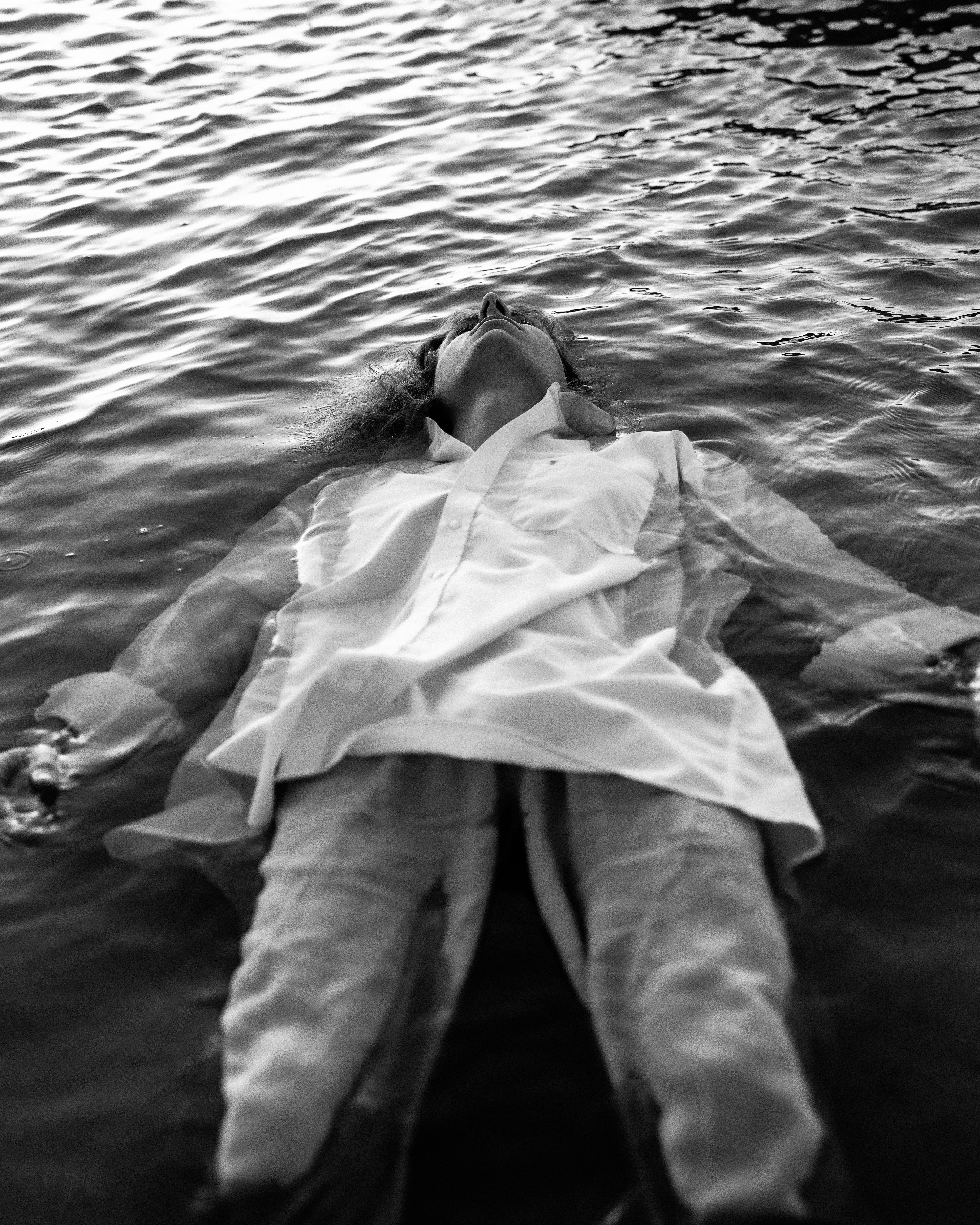 Contemplative Woman Floating in Calm Water · Free Stock Photo