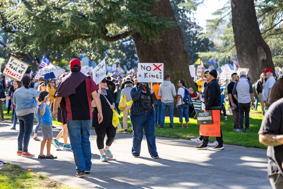People gather at the Sacramento Capitol for a protest against tyranny, with signs advocating for freedom and immigration rights.