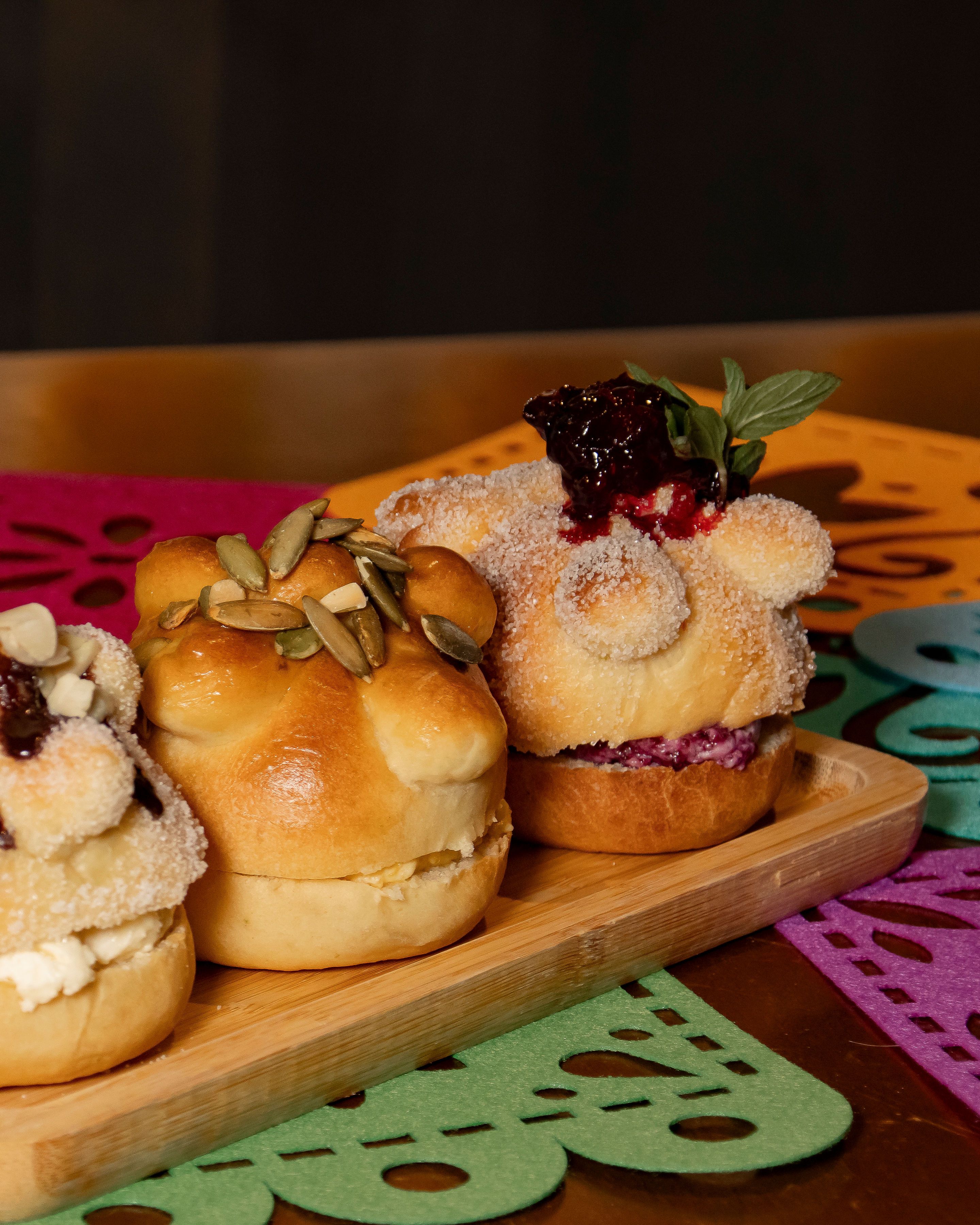 Delicious conchas bread with various toppings on a vibrant background, perfect for a festive occasion.