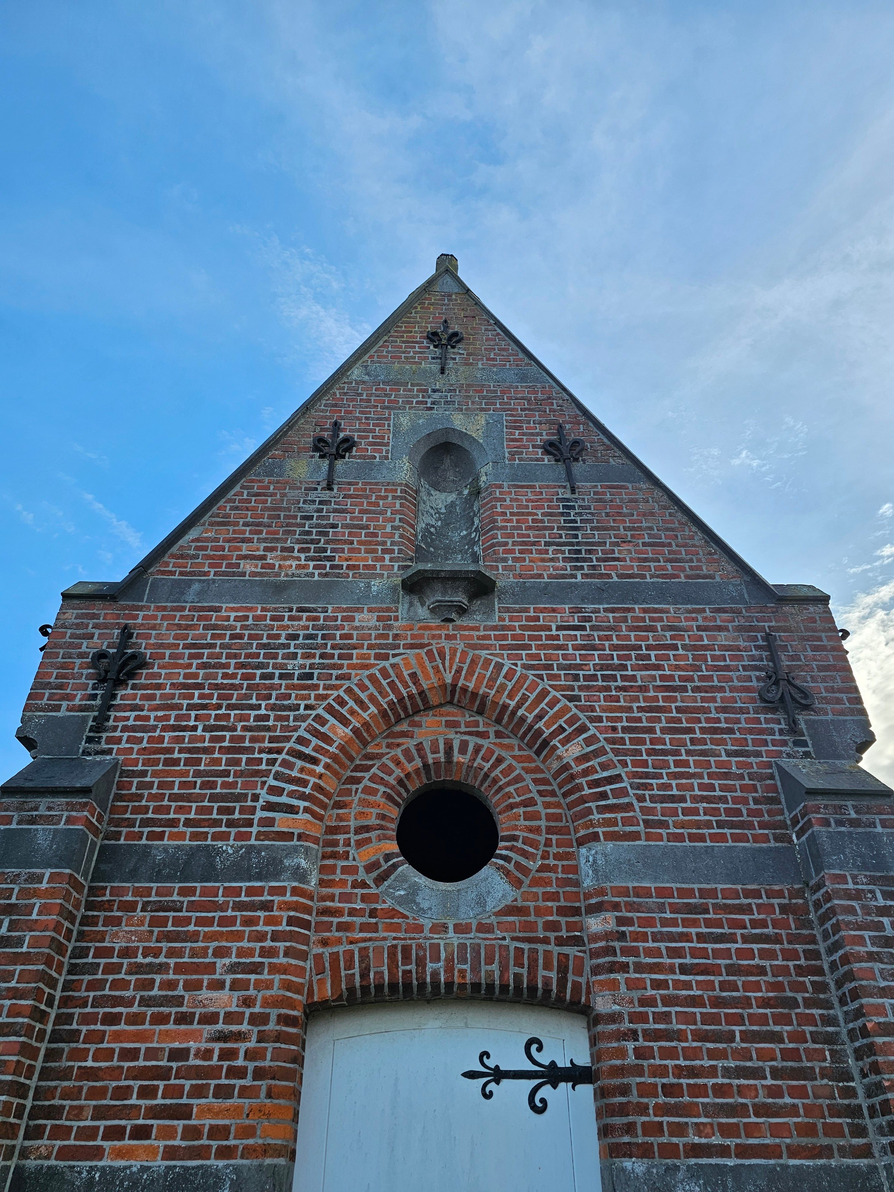 Historic Brick Church Facade Against Blue Sky · Free Stock Photo