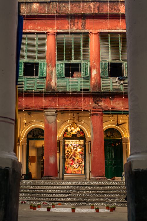 Free A charming view of an old colonial building with red arches and green shutters. Stock Photo