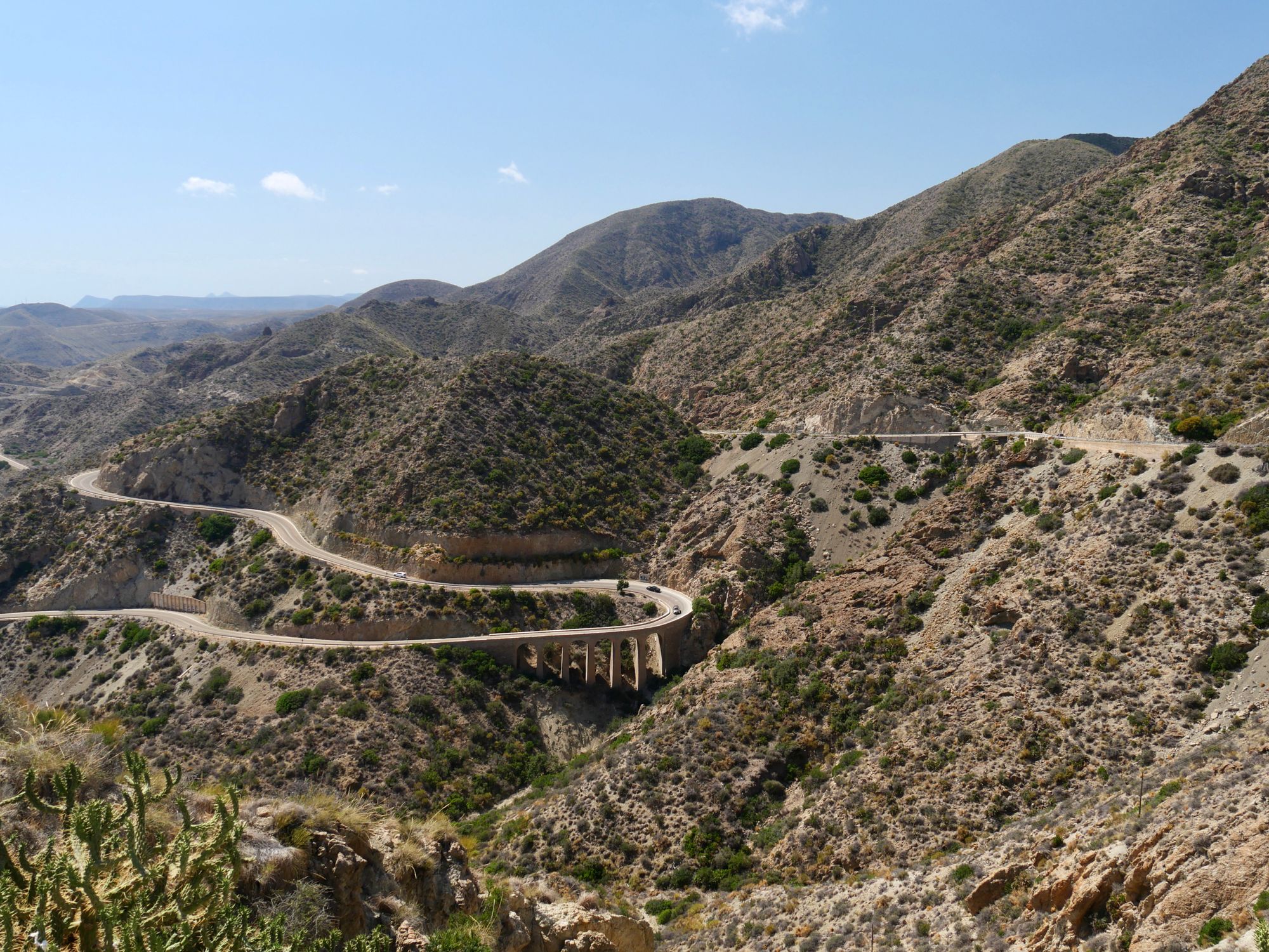 A winding road through the rugged mountains of Spain, offering a breathtaking view.