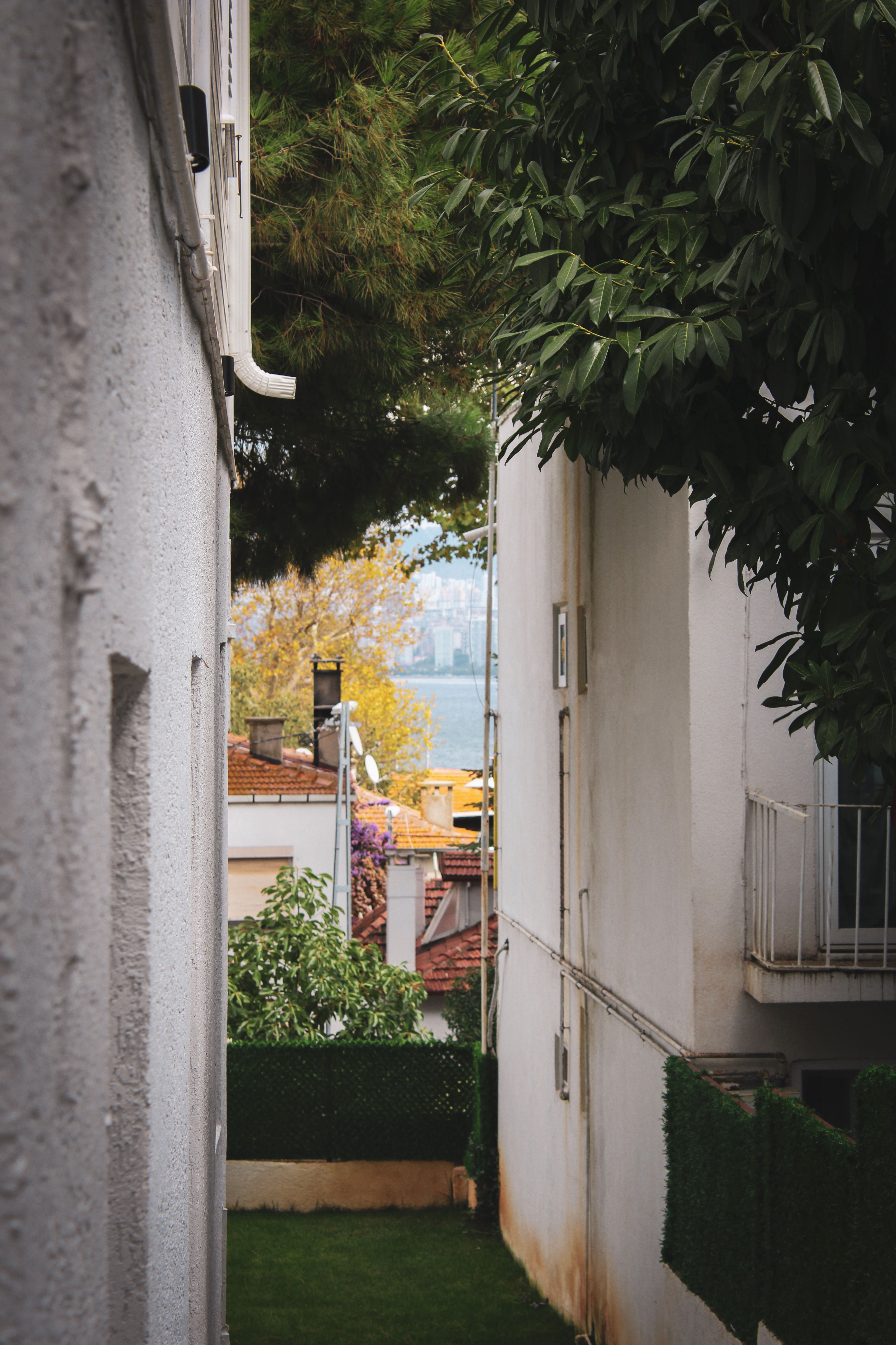 Narrow Alleyway View Leading to Urban Landscape · Free Stock Photo