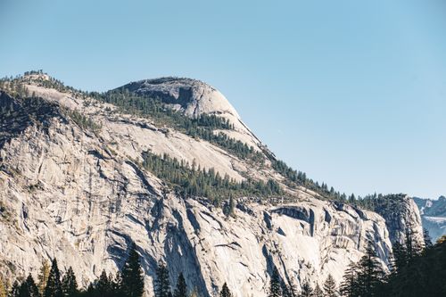 Free Breathtaking shot of Half Dome in Yosemite National Park, showcasing majestic granite cliffs under clear blue skies. Stock Photo