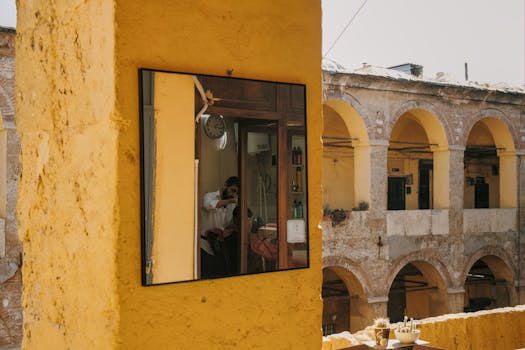 Reflective view of a classic barbershop inside a historic courtyard in Istanbul, Türkiye.