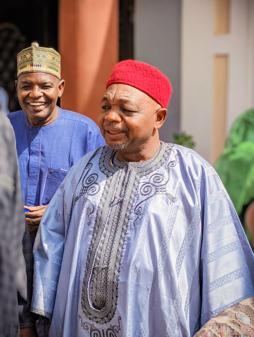Free Two African men wearing vibrant traditional clothing smile outdoors in sunlight. Stock Photo