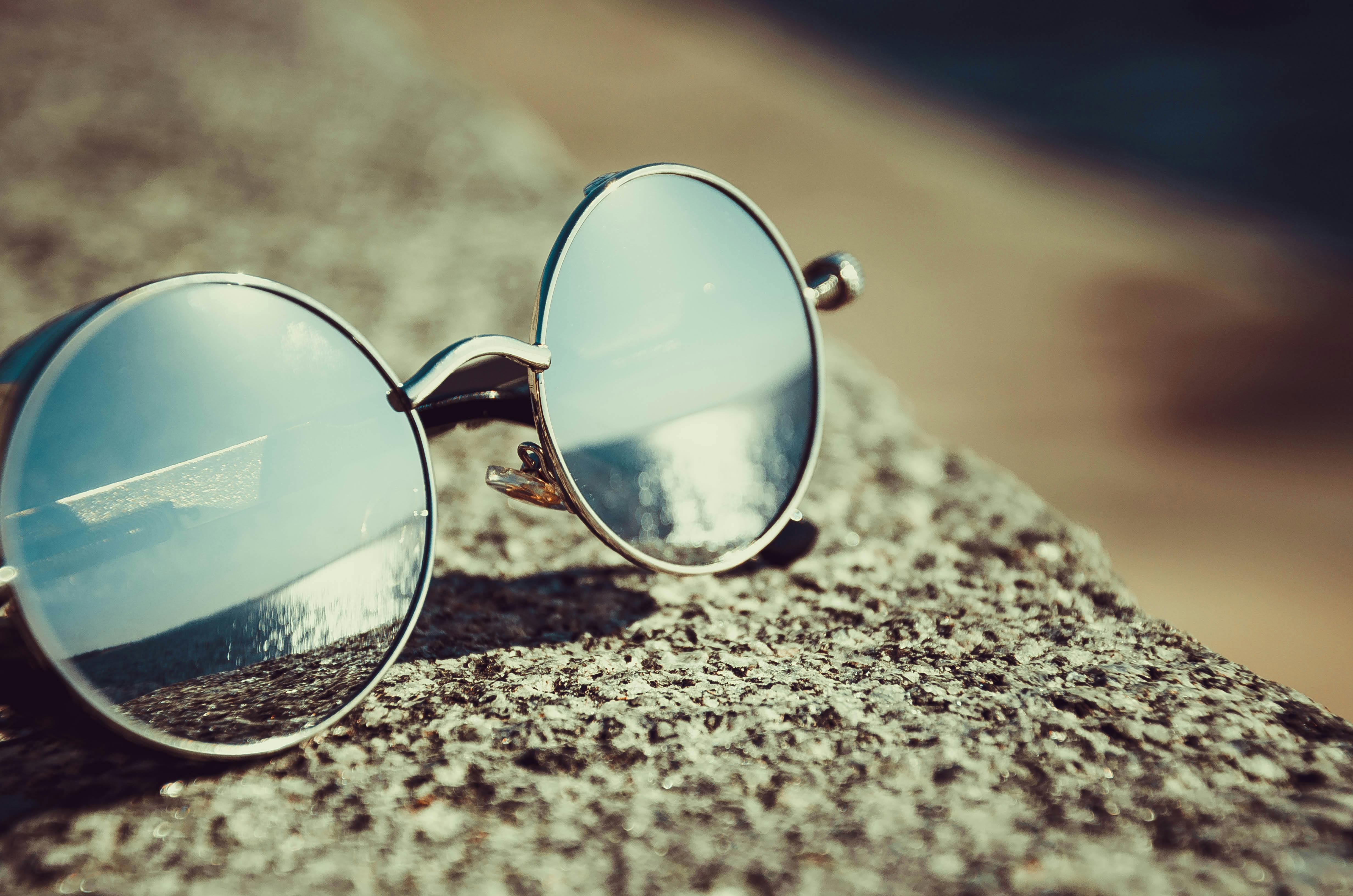 Silver Framed Hippie Sunglasses on Concrete Free Stock Photo