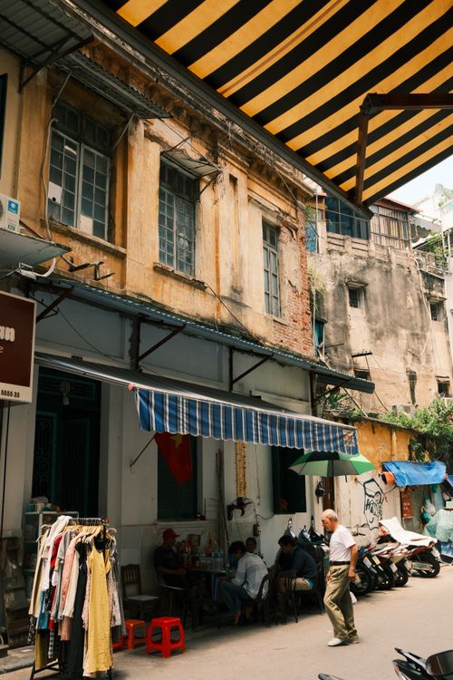 Free Charming street scene in a historic Hong Kong alley with locals and colorful awnings. Stock Photo