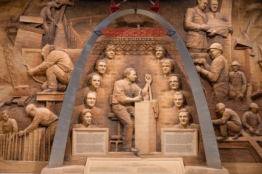 An elaborate relief sculpture depicting builders with a focus on historical figures and construction.