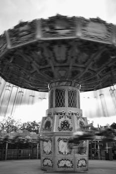 A vibrant black and white photograph of a spinning swing ride at a fair in North Carolina.