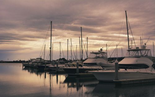 Free Serene marina view at sunset with docked yachts reflecting on calm waters. Stock Photo