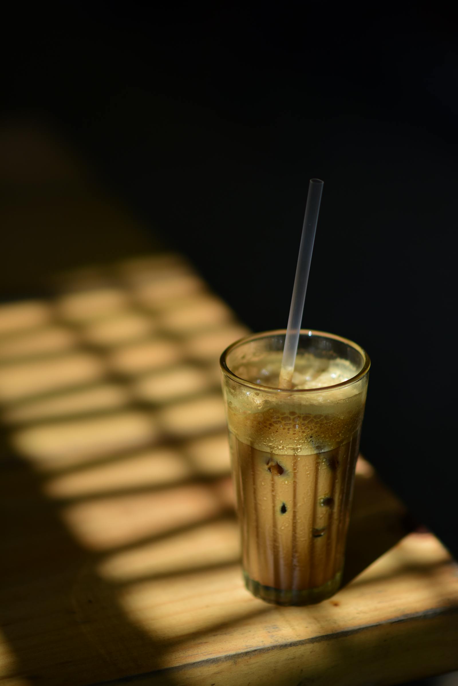 Cold brew over ice in a glass with window light