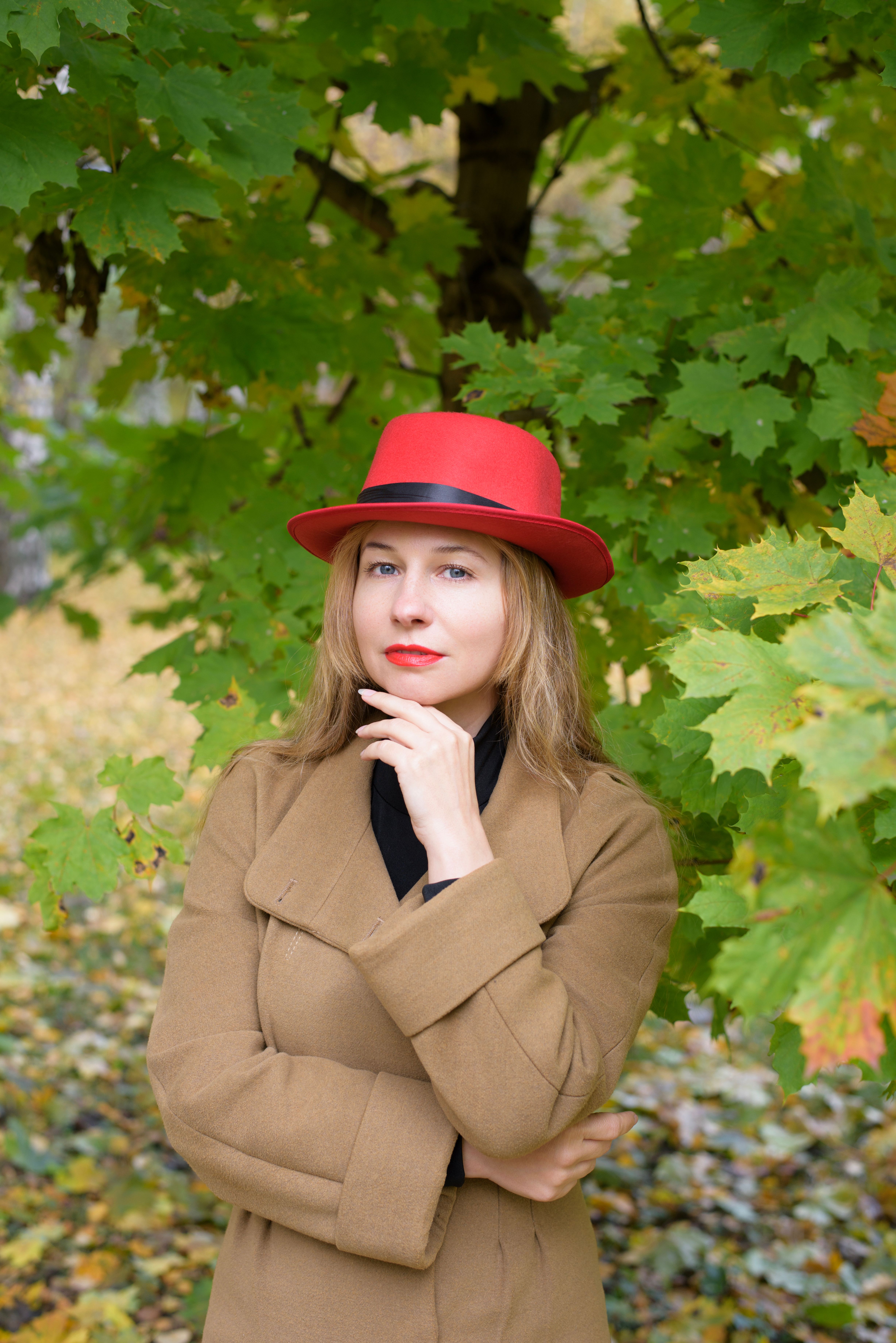 Portrait of Woman in Autumn Leaves with Red Hat · Free Stock Photo